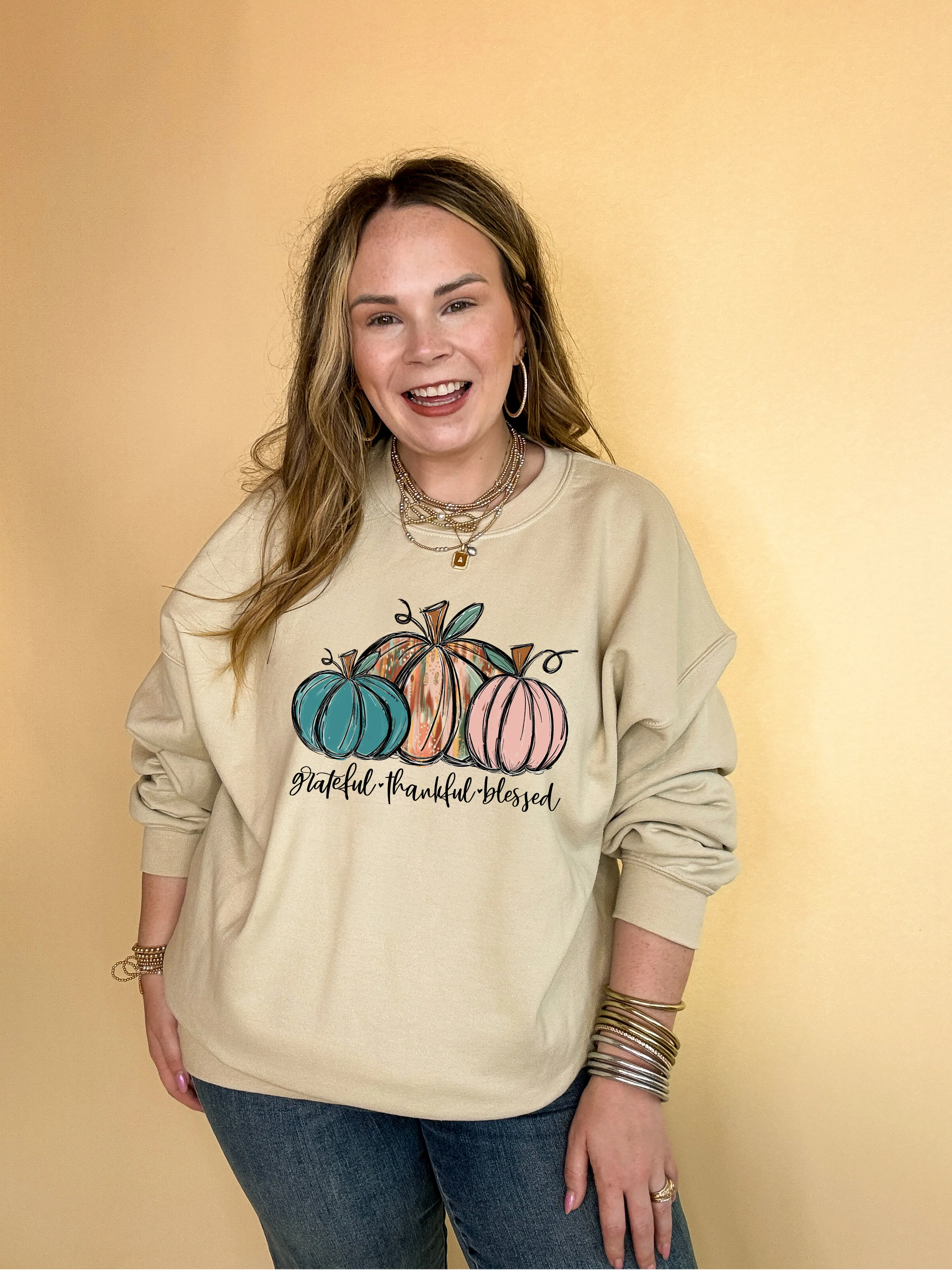 Online Exclusive | Grateful, Thankful and Blessed Three Painted Pumpkin Graphic Sweatshirt in Multiple Color Options